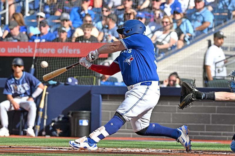 Sep 28, 2025; Toronto, Ontario, CAN;  Toronto Blue Jays catcher Alejandro Kirk (30) hits a grand slam home run against the Tampa Bay Rays in the first inning at Rogers Centre. Mandatory Credit: Dan Hamilton-Imagn Images
