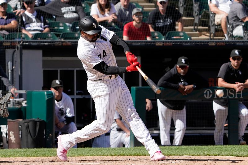 Jun 30, 2024; Chicago, Illinois, USA; Chicago White Sox designated hitter Eloy Jiménez (74) hits a single against the Colorado Rockies during the thirteenth inning at Guaranteed Rate Field. Mandatory Credit: David Banks-USA TODAY Sports