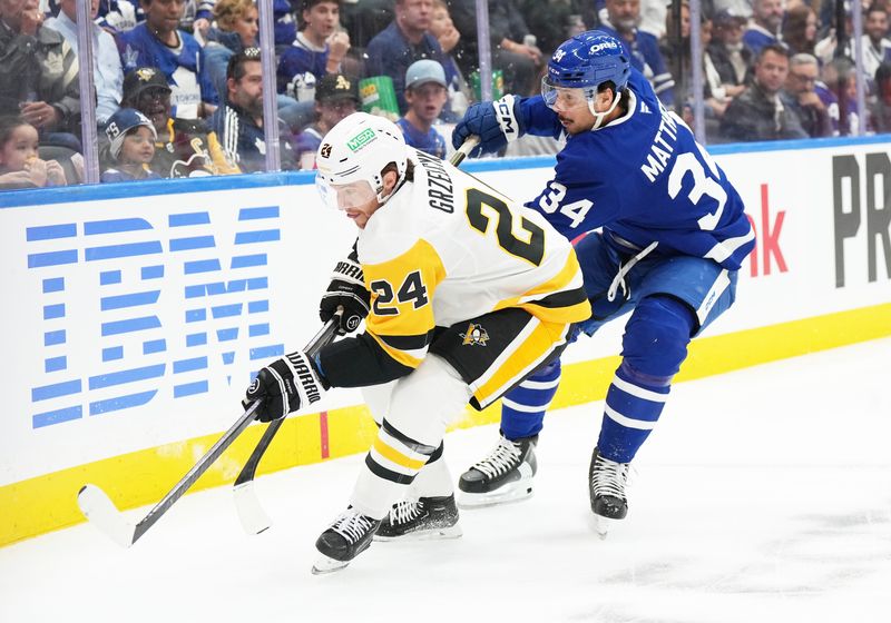 Oct 12, 2024; Toronto, Ontario, CAN; Toronto Maple Leafs center Auston Matthews (34) and Pittsburgh Penguins defenseman Matt Grzelcyk (24) battle for the puck during the first period at Scotiabank Arena. Mandatory Credit: Nick Turchiaro-Imagn Images