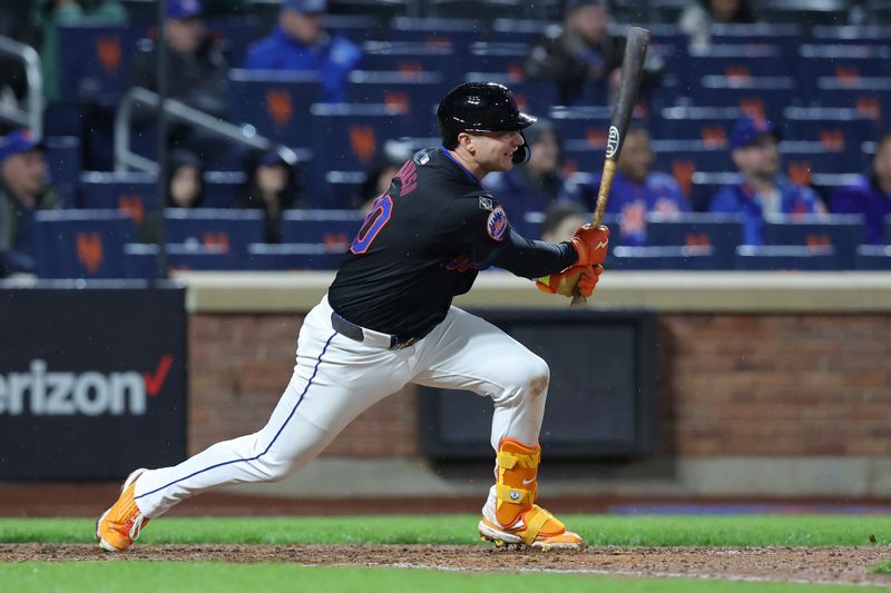 May 10, 2024; New York City, New York, USA; New York Mets first baseman Pete Alonso (20) follows through on an RBI single against the Atlanta Braves during the ninth inning at Citi Field. Mandatory Credit: Brad Penner-USA TODAY Sports