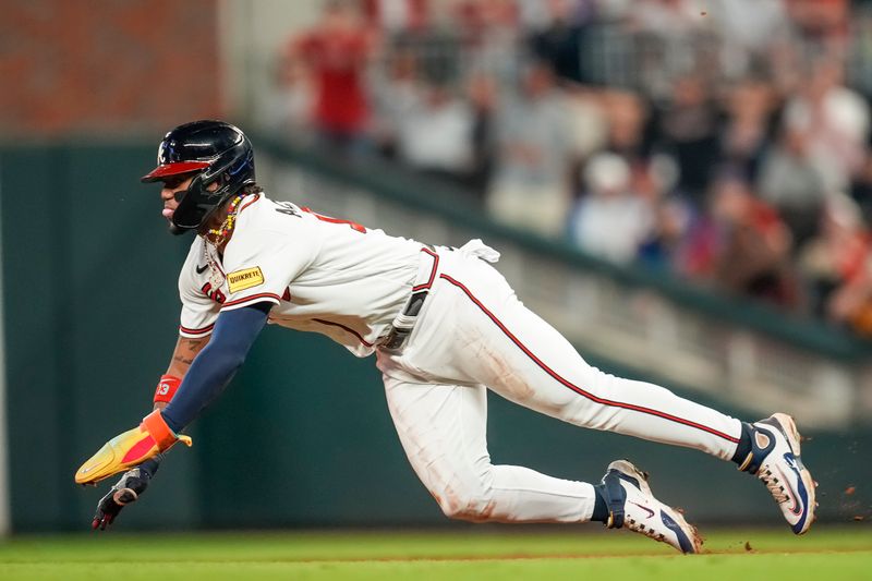 Sep 27, 2023; Cumberland, Georgia, USA; Atlanta Braves right fielder Ronald Acuna Jr. (13) steals a base against the Chicago Cubs during the eighth inning at Truist Park. Mandatory Credit: Dale Zanine-USA TODAY Sports