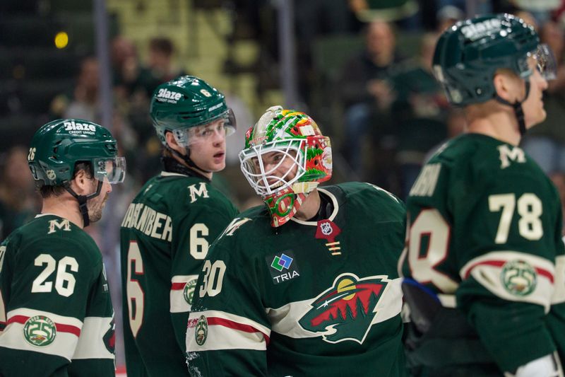 Apr 14, 2026; Saint Paul, Minnesota, USA; Minnesota Wild goaltender Jesper Wallstedt (30) reacts to teammates congratulating him after saving a Anaheim Ducks shot in the third period at Grand Casino Arena. Mandatory Credit: Matt Blewett-Imagn Images