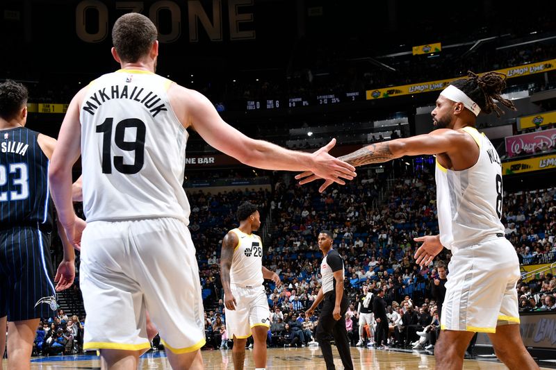 ORLANDO, FL - JANUARY 5 :  Svi Mykhailiuk #19 and Patty Mills #8 of the Utah Jazz high five during the game against the Orlando Magic on January 5, 2025 at Kia Center in Orlando, Florida. NOTE TO USER: User expressly acknowledges and agrees that, by downloading and or using this photograph, User is consenting to the terms and conditions of the Getty Images License Agreement. Mandatory Copyright Notice: Copyright 2025 NBAE (Photo by Fernando Medina/NBAE via Getty Images)