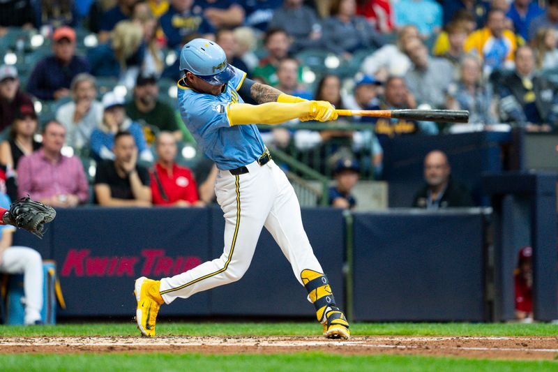 Aug 9, 2024; Milwaukee, Wisconsin, USA;  Milwaukee Brewers third baseman Joey Ortiz (3) hits an RBI double during the second inning inning against the Cincinnati Reds at American Family Field. Mandatory Credit: Jeff Hanisch-USA TODAY Sports