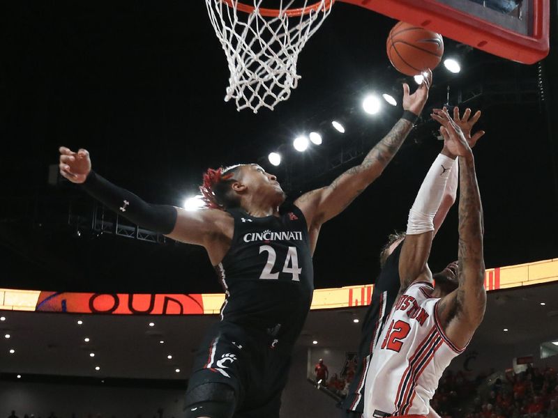 Jan 28, 2023; Houston, Texas, USA; Cincinnati Bearcats guard Jeremiah Davenport (24) reaches for an offensive rebound against Houston Cougars guard Tramon Mark (12)  in the second half at Fertitta Center. Houston Cougars won 75 to 69 .Mandatory Credit: Thomas Shea-USA TODAY Sports