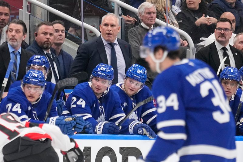 Apr 20, 2025; Toronto, Ontario, CAN; Toronto Maple Leafs head coach Craig Berube (center) watches the action during the third period of game one of the first round of the 2025 Stanley Cup Playoffs against the Ottawa Senators at Scotiabank Arena. Mandatory Credit: John E. Sokolowski-Imagn Images
