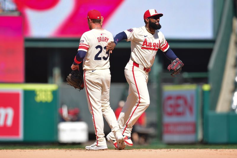 Jul 14, 2024; Anaheim, California, USA; Los Angeles Angels third baseman Brandon Drury (23) and right fielder Jo Adell (7) celebrate the victory against the Seattle Mariners at Angel Stadium. Mandatory Credit: Gary A. Vasquez-USA TODAY Sports