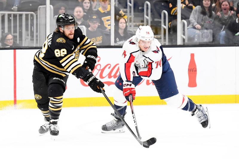 Oct 3, 2023; Boston, Massachusetts, USA; Boston Bruins right wing David Pastrnak (88) and Washington Capitals defenseman John Carlson (74) battle for the puck during overtime at TD Garden. Mandatory Credit: Bob DeChiara-USA TODAY Sports