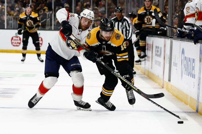 Mar 11, 2025; Boston, Massachusetts, USA; Florida Panthers center Sam Bennett (9) tries to hold up Boston Bruins center John Beecher (19) during the first period at TD Garden. Mandatory Credit: Winslow Townson-Imagn Images