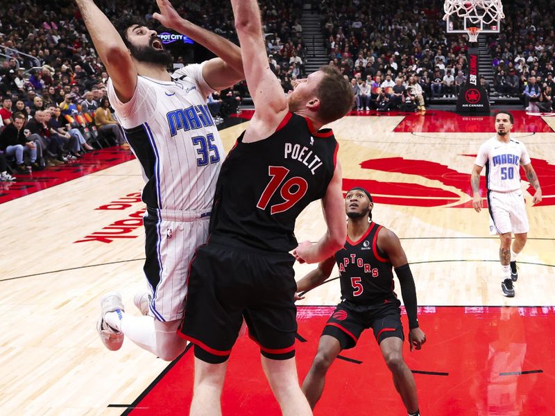 TORONTO, CANADA - JANUARY 3: Goga Bitadze #35 of the Orlando Magic drives to the basket during the game against the Toronto Raptors on January 3, 2025 at the Scotiabank Arena in Toronto, Ontario, Canada.  NOTE TO USER: User expressly acknowledges and agrees that, by downloading and or using this Photograph, user is consenting to the terms and conditions of the Getty Images License Agreement.  Mandatory Copyright Notice: Copyright 2025 NBAE (Photo by Vaughn Ridley/NBAE via Getty Images)