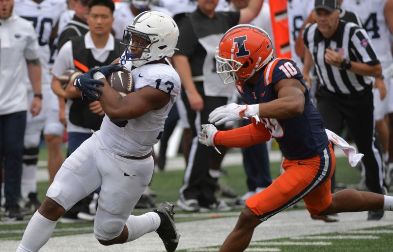 Sep 16, 2023; Champaign, Illinois, USA;  Penn State Nittany Lions running back Kaytron Allen (13) runs against Illinois Fighting Illini defensive lineman Mason Muragin (18) during the second half at Memorial Stadium. Mandatory Credit: Ron Johnson-USA TODAY Sports