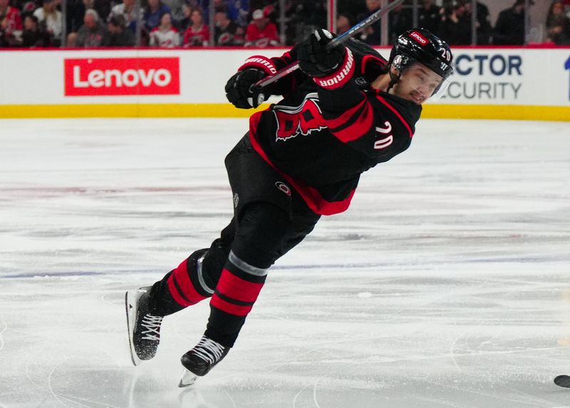 Mar 12, 2024; Raleigh, North Carolina, USA; Carolina Hurricanes center Sebastian Aho (20) takes a shot against the New York Rangers during the first period at PNC Arena. Mandatory Credit: James Guillory-USA TODAY Sports