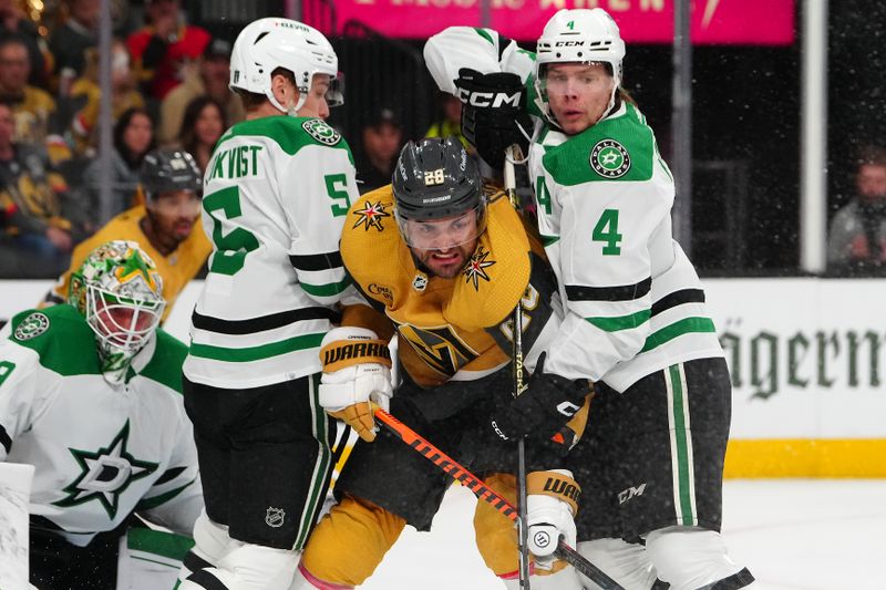 May 3, 2024; Las Vegas, Nevada, USA; Vegas Golden Knights left wing William Carrier (28) is checked by Dallas Stars defenseman Nils Lundkvist (5) and defenseman Miro Heiskanen (4) during the first period of game six of the first round of the 2024 Stanley Cup Playoffs at T-Mobile Arena. Mandatory Credit: Stephen R. Sylvanie-USA TODAY Sports