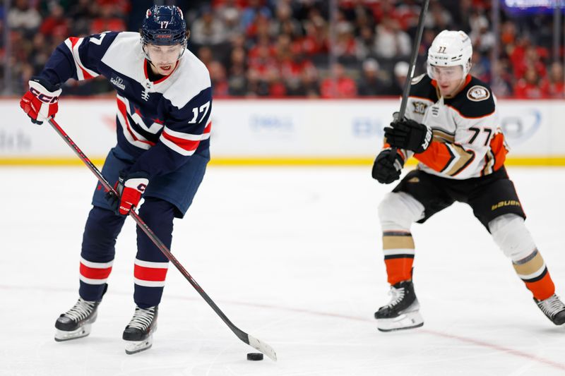 Jan 16, 2024; Washington, District of Columbia, USA; Washington Capitals center Dylan Strome (17) clears the puck from Anaheim Ducks right wing Frank Vatrano (77) in the second period at Capital One Arena. Mandatory Credit: Geoff Burke-USA TODAY Sports