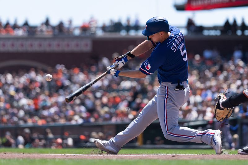 Aug 13, 2023; San Francisco, California, USA; Texas Rangers shortstop Corey Seager (5) hits a single during the first inning against the San Francisco Giants at Oracle Park. Mandatory Credit: Stan Szeto-USA TODAY Sports