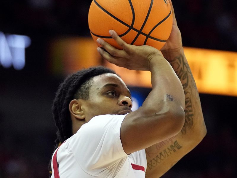 Feb 18, 2023; Madison, Wisconsin, USA;  Wisconsin Badgers guard Kamari McGee (4) makes a three-pointer during the second half against the Rutgers Scarlet Knights at the Kohl Center. Mandatory Credit: Kayla Wolf-USA TODAY Sports