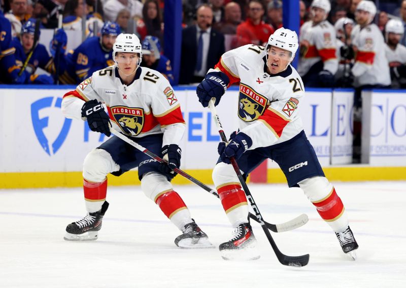 Feb 15, 2024; Buffalo, New York, USA;  Florida Panthers center Anton Lundell (15) watches as center Nick Cousins (21) takes a shot on goal during the first period against the Buffalo Sabres at KeyBank Center. Mandatory Credit: Timothy T. Ludwig-USA TODAY Sports