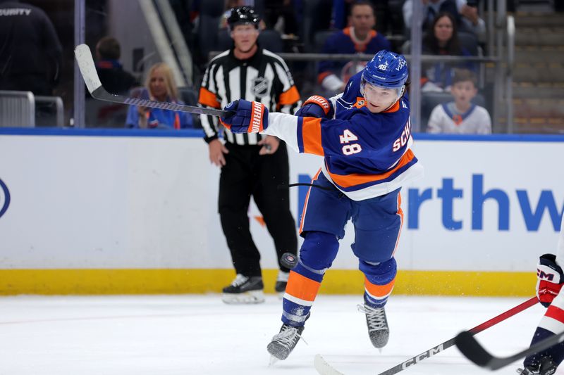 Oct 11, 2025; Elmont, New York, USA; New York Islanders defenseman Matthew Schaefer (48) takes a shot against the Washington Capitals during the second period at UBS Arena. Mandatory Credit: Brad Penner-Imagn Images