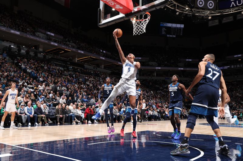 MINNEAPOLIS, MN -  FEBRUARY 2: Paolo Banchero #5 of the Orlando Magic shoots the ball during the game against the Minnesota Timberwolves on February 2, 2024 at Target Center in Minneapolis, Minnesota. NOTE TO USER: User expressly acknowledges and agrees that, by downloading and or using this Photograph, user is consenting to the terms and conditions of the Getty Images License Agreement. Mandatory Copyright Notice: Copyright 2024 NBAE (Photo by David Sherman/NBAE via Getty Images)