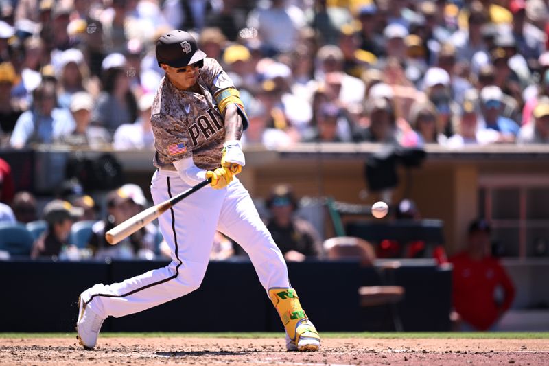 Jun 25, 2023; San Diego, California, USA; San Diego Padres third baseman Manny Machado (13) hits a single against the Washington Nationals during the fourth inning at Petco Park. Mandatory Credit: Orlando Ramirez-USA TODAY Sports