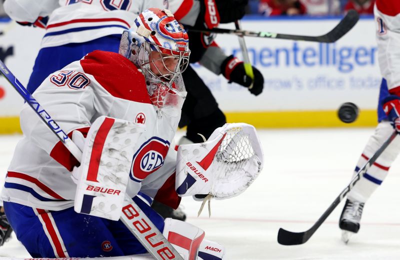 Dec 9, 2023; Buffalo, New York, USA;  Montreal Canadiens goaltender Cayden Primeau (30) looks to make a save during the second period against the Buffalo Sabres at KeyBank Center. Mandatory Credit: Timothy T. Ludwig-USA TODAY Sports