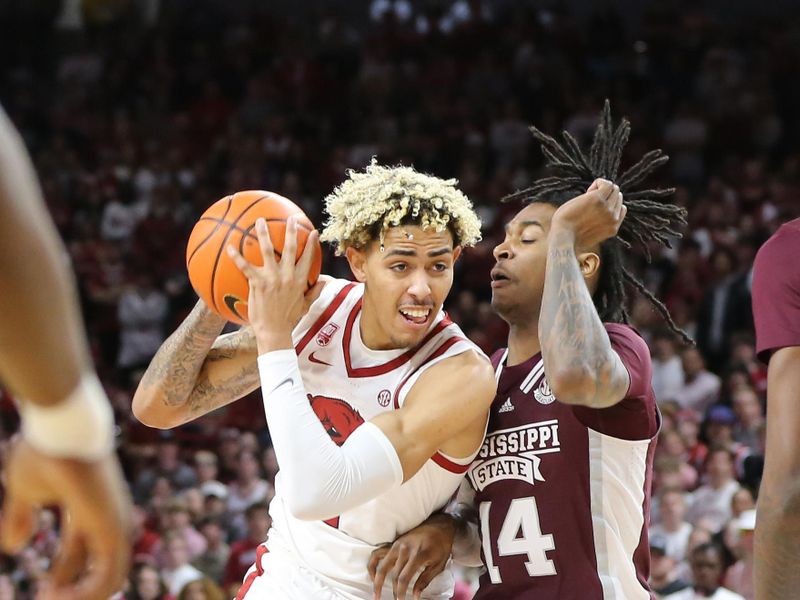 Feb 11, 2023; Fayetteville, Arkansas, USA; Arkansas Razorbacks forward Jean Graham (11) drives against Mississippi State Bulldogs forward Tyler Stevenson (14) during the first half at Bud Walton Arena. Mandatory Credit: Nelson Chenault-USA TODAY Sports