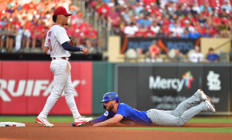 Jun 25, 2025; St. Louis, Missouri, USA; Chicago Cubs first baseman Michael Busch (29) dives for second as he steals the base in the fourth inning as St. Louis Cardinals shortstop Masyn Winn (0) waits on the throw at Busch Stadium. Mandatory Credit: Tim Vizer-Imagn Images 