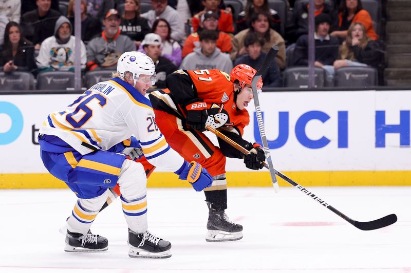 Nov 22, 2024; Anaheim, California, USA; Buffalo Sabres defenseman Rasmus Dahlin (26) loses his stick as Anaheim Ducks defenseman Olen Zellweger (51) shoots during overtime at Honda Center. Mandatory Credit: Ryan Sun-Imagn Images