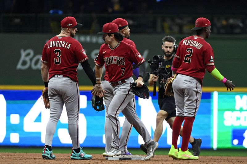 Oct 3, 2023; Milwaukee, Wisconsin, USA; Arizona Diamondbacks third baseman Evan Longoria (3) and left fielder Corbin Carroll (7) celebrate with teammates after defeating the Milwaukee Brewers in game one of the Wildcard series for the 2023 MLB playoffs at American Family Field. Mandatory Credit: Michael McLoone-USA TODAY Sports