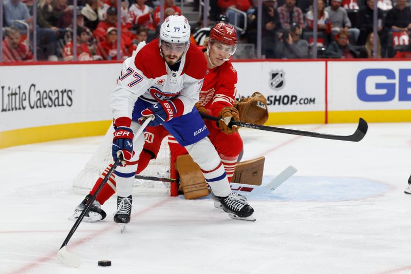 Oct 9, 2025; Detroit, Michigan, USA;   Montréal Canadiens center Kirby Dach (77) and Detroit Red Wings defenseman Simon Edvinsson (77)  battle for the puck in the first period at Little Caesars Arena. Mandatory Credit: Rick Osentoski-Imagn Images