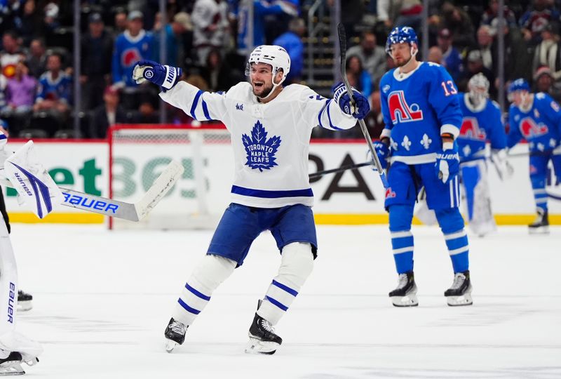 Jan 12, 2026; Denver, Colorado, USA; Toronto Maple Leafs center Scott Laughton (24) celebrates defeating the Colorado Avalanche in overtime at Ball Arena. Mandatory Credit: Ron Chenoy-Imagn Images