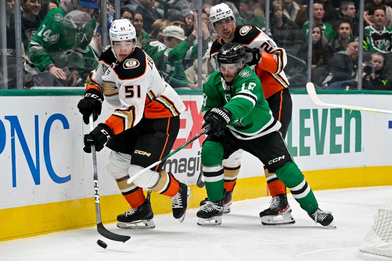 Jan 25, 2024; Dallas, Texas, USA; Anaheim Ducks defenseman Olen Zellweger (51) and Dallas Stars center Sam Steel (18) chase the puck during the second period at the American Airlines Center. Mandatory Credit: Jerome Miron-USA TODAY Sports