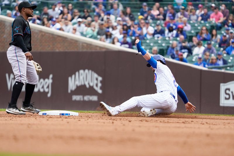 May 6, 2023; Chicago, Illinois, USA; Chicago Cubs left fielder Ian Happ (8) is safe at second base as Miami Marlins shortstop Xavier Edwards (63) stands nearby during the first inning at Wrigley Field. Mandatory Credit: David Banks-USA TODAY Sports