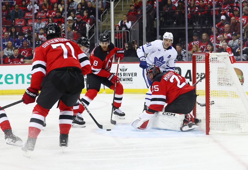 Oct 10, 2024; Newark, New Jersey, USA; New Jersey Devils goaltender Jacob Markstrom (25) makes a save against the Toronto Maple Leafs during the first period at Prudential Center. Mandatory Credit: Ed Mulholland-Imagn Images