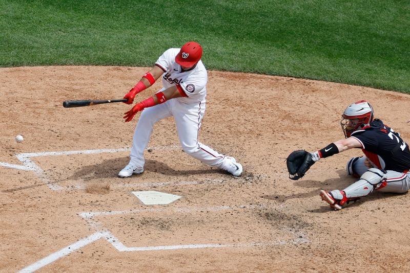 May 22, 2024; Washington, District of Columbia, USA; Washington Nationals pinch hitter Keibert Ruiz (20) hits an RBI ground out against the Minnesota Twins during the seventh inning at Nationals Park. Mandatory Credit: Geoff Burke-USA TODAY Sports