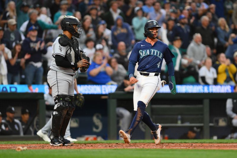 Jun 11, 2024; Seattle, Washington, USA; Seattle Mariners third baseman Josh Rojas (4) scores a run against the Chicago White Sox during the seventh inning at T-Mobile Park. Mandatory Credit: Steven Bisig-USA TODAY Sports