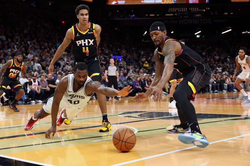 PHOENIX, ARIZONA - DECEMBER 03: Harrison Barnes #40 of the San Antonio Spurs dives for a loose ball against Bradley Beal #3 of the Phoenix Suns during the second half of the Emirates NBA Cup game at Footprint Center on December 03, 2024 in Phoenix, Arizona. NOTE TO USER: User expressly acknowledges and agrees that, by downloading and or using this photograph, User is consenting to the terms and conditions of the Getty Images License Agreement.  (Photo by Chris Coduto/Getty Images)