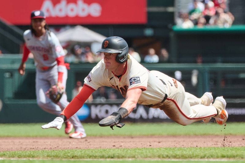 Apr 10, 2024; San Francisco, California, USA; San Francisco Giants shortstop Tyler Fitzgerald (49) slides headfirst into third base with a stolen base against the Washington Nationals during the second inning at Oracle Park. Mandatory Credit: Robert Edwards-USA TODAY Sports