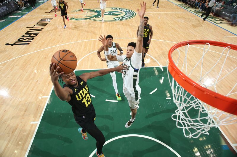 MILWAUKEE, WI - NOVEMBER 7: Isaiah Collier #13 of the Utah Jazz drives to the basket during the game against the Milwaukee Bucks on November 7, 2024 at Fiserv Forum Center in Milwaukee, Wisconsin. NOTE TO USER: User expressly acknowledges and agrees that, by downloading and or using this Photograph, user is consenting to the terms and conditions of the Getty Images License Agreement. Mandatory Copyright Notice: Copyright 2024 NBAE (Photo by Gary Dineen/NBAE via Getty Images).