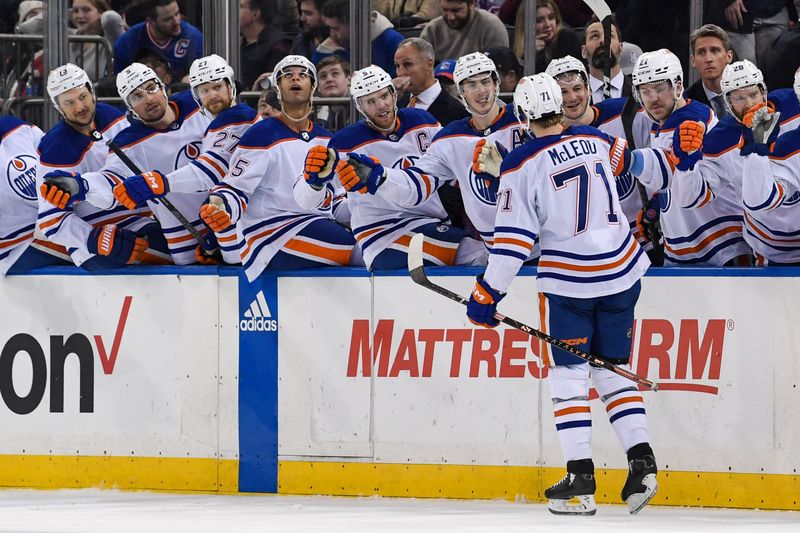 Dec 22, 2023; New York, New York, USA;  Edmonton Oilers center Ryan McLeod (71) celebrates his goal against the New York Rangers with the against the Edmonton Oilers bench during the third period at Madison Square Garden. Mandatory Credit: Dennis Schneidler-USA TODAY Sports