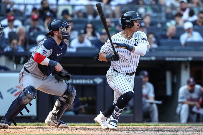 Sep 15, 2024; Bronx, New York, USA;  New York Yankees first baseman Oswaldo Cabrera (95) hits a single in the eighth inning against the Boston Red Sox at Yankee Stadium. Mandatory Credit: Wendell Cruz-Imagn Images