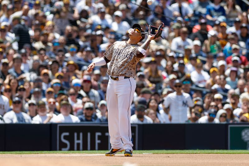 May 26, 2024; San Diego, California, USA; San Diego Padres third baseman Manny Machado (13) makes the catch at third base to end the top of the fourth inning against the New York Yankees at Petco Park. Mandatory Credit: David Frerker-USA TODAY Sports