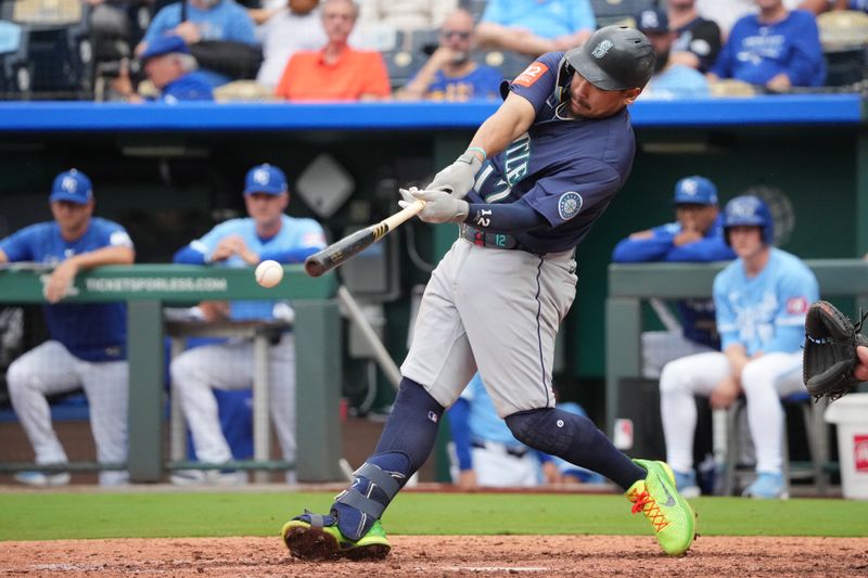 Sep 18, 2025; Kansas City, Missouri, USA; Seattle Mariners first baseman Josh Naylor (12) hits a single against the Kansas City Royals during the ninth inning at Kauffman Stadium. Mandatory Credit: Denny Medley-Imagn Images