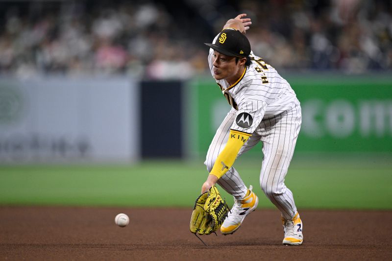 Aug 15, 2023; San Diego, California, USA; San Diego Padres second baseman Ha-seong Kim (7) fields a ground ball during the fifth inning against the Baltimore Orioles at Petco Park. Mandatory Credit: Orlando Ramirez-USA TODAY Sports