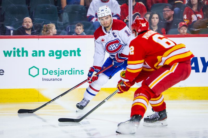 Mar 16, 2024; Calgary, Alberta, CAN; Montreal Canadiens center Nick Suzuki (14) controls the puck against the Calgary Flames during the third period at Scotiabank Saddledome. Mandatory Credit: Sergei Belski-USA TODAY Sports