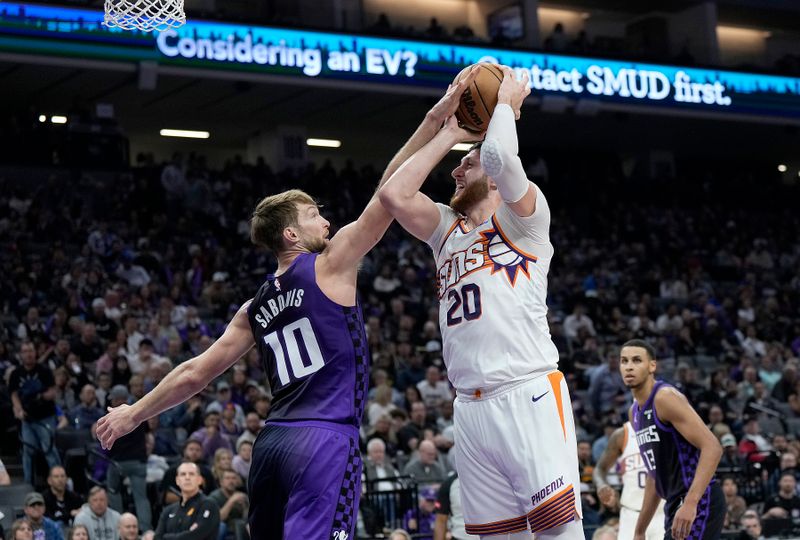 SACRAMENTO, CALIFORNIA - APRIL 12: Jusuf Nurkic #20 of the Phoenix Suns is fouled by Domantas Sabonis #10 of the Sacramento Kings during the first half at Golden 1 Center on April 12, 2024 in Sacramento, California. NOTE TO USER: User expressly acknowledges and agrees that, by downloading and or using this photograph, User is consenting to the terms and conditions of the Getty Images License Agreement. (Photo by Thearon W. Henderson/Getty Images)