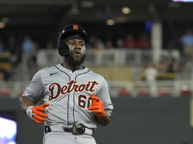 Jul 3, 2024; Minneapolis, Minnesota, USA; Detroit Tigers outfielder Akil Baddoo (60) heads to third on a stand-up triple against the Minnesota Twins during the ninth inning at Target Field. Mandatory Credit: Nick Wosika-USA TODAY Sports