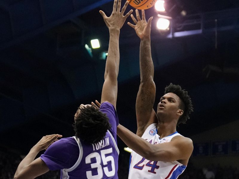 Jan 31, 2023; Lawrence, Kansas, USA; Kansas Jayhawks forward K.J. Adams Jr. (24) shoots over Kansas State Wildcats forward Nae'Qwan Tomlin (35) during the second half at Allen Fieldhouse. Mandatory Credit: Jay Biggerstaff-USA TODAY Sports