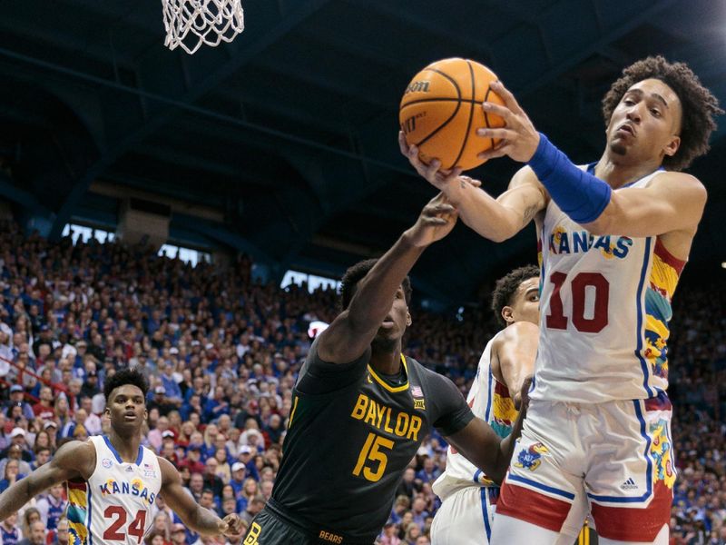 Feb 18, 2023; Lawrence, Kansas, USA; Kansas Jayhawks forward Jalen Wilson (10) grabs a rebound in front of Baylor Bears forward Josh Ojianwuna (15) during the first half at Allen Fieldhouse. Mandatory Credit: William Purnell-USA TODAY Sports