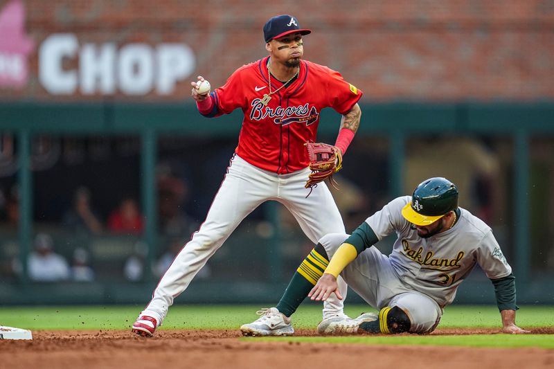 May 31, 2024; Cumberland, Georgia, USA; Atlanta Braves shortstop Orlando Arcia (11) watches a base runner after forcing out Oakland Athletics third baseman Abraham Toro (31) at second base during the third inning at Truist Park. Mandatory Credit: Dale Zanine-USA TODAY Sports